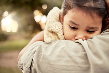 Image showing Hug, park and sad girl with parent for comfort, care and support while outdoors in nature. Family, love and mom embracing, hugging and holding child in arms comforting worried, upset and unhappy kid