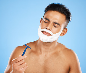 Image showing Shaving, grooming and hygiene, man with razor for clean and fresh face, cream and foam product with blue studio background. Facial wellness, healthy skin and skincare, beauty and check blade.