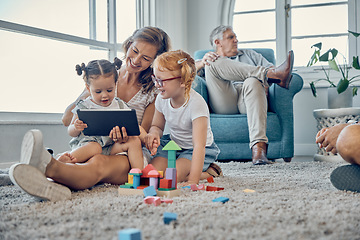 Image showing Tablet, carpet and family with children for elearning, teaching and online games with mother, grandparents and baby in living room. Talking, education and mom helping kids on digital platform at home