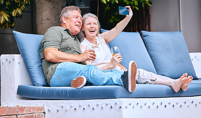 Image showing Selfie, relax and senior couple with a drink on an outdoor sofa on holiday in Costa Rica. Retirement, alcohol and happy elderly man and woman with a phone for photo, smile and memory on a vacation