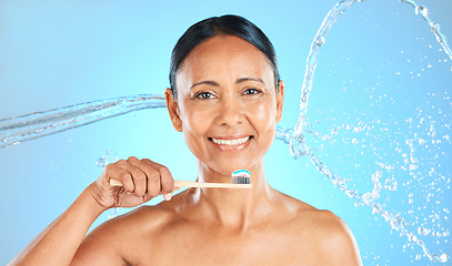 Image showing Dental, toothpaste and senior woman brushing teeth with water splash, toothbrush or self care product for enamel healthcare. Oral wellness, dental care routine and elderly beauty model cleaning tooth