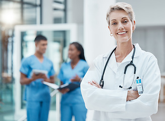 Image showing Woman, doctor and smile of a proud medical worker with nurse group feeling success. Healthcare, medicine and happy health worker in a hospital and wellness clinic ready for working and assistance