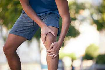 Image showing Knee pain, hands and man with injury during exercise, training and running in a park, pain and inflammation. Hand, fitness and arthritis in leg of runner during workout, sport and practice outdoors