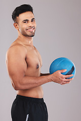 Image showing Fitness, health and man with a ball for training, workout and sports against a grey mockup studio background. Happy, cardio and portrait of a young athlete with a smile for exercise and health