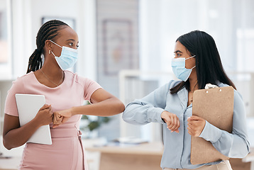 Image showing Covid, greeting and teamwork with a business woman and colleague in business working together in their office. Collaboration, diversity and mask with an employee team during the corona virus pandemic