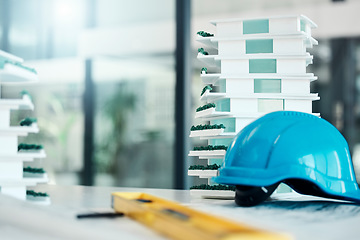 Image showing Building model on table, construction design industry and safety helmet for industrial real estate job. 3d plastic apartment architecture project, engineering career and contractor equipment tools