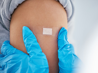 Image showing Hands, plaster and arm in covid vaccine for injection, cure or jab at doctor appointment by the hospital. Hand of healthcare GP applying bandage to patient for vaccination, immunization or booster