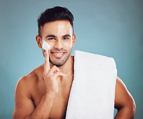 Image showing Beauty, shaving and cream portrait of man happy with preparation for grooming, cleaning and facial hair removal. Hygiene cosmetic model with shave foam on face and smile in teal studio with mockup.