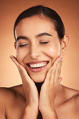 Image showing Face, beauty smile and woman with eyes closed on brown studio background. Makeup, skincare and female model from Australia with hands on face for smooth skin routine, perfect teeth and wellness.