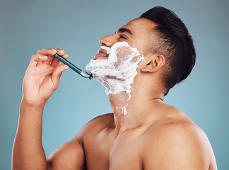 Image showing Studio, skincare and man shaving his beard in a daily morning grooming routine with a razor in Mexico. Smile, wellness and happy Latino person shaves his mustache or facial hair for self care hygiene