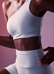 Image showing Woman, runner athlete and abdomen closeup for sportswear advertising or fitness training. Young black sports girl, abs exercise motivation and healthy cardio lifestyle in pink background studio