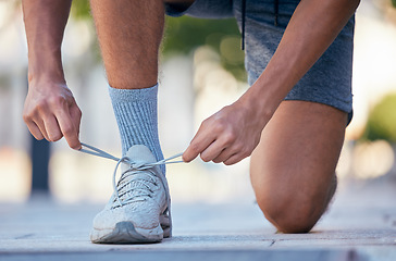 Image showing Fitness, running and tie shoes of man in street for training, exercise and health lifestyle. Jogger, cardio and stamina with runner and sneakers in outdoor for endurance, sprinting and motivation