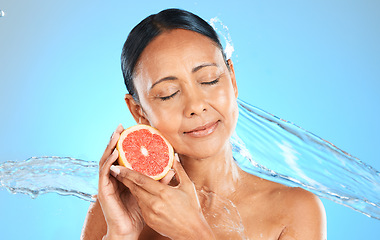 Image showing Water splash, fruit and skincare wellness of a woman with a grapefruit feeling health and beauty. Diet, nutrition and healthy skin of a model with natural organic produce feeling calm and peace