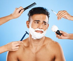 Image showing Studio makeover, unhappy man and beauty by hands of professional stylist team grooming on a blue background mockup. Cleaning, hygiene and skincare with wellness model, new look and hand of assistance