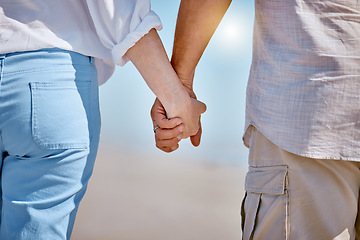 Image showing Love, summer and old couple holding hands at beach enjoying ocean waves, blue sky and nature. Affection, bonding and loving man and woman taking romantic walk by sea on holiday, vacation and weekend