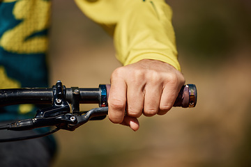 Image showing Hand, handle and bike with a man athlete or cyclist riding outdoor for fitness, exercise or cardio. Workout, health grip with a male bicycle rider holding on a handlebar while outdoor for endurance