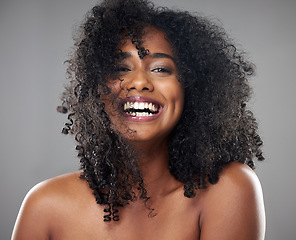 Image showing Face, hair care and beauty smile of black woman on gray studio background. Portrait, makeup and female model from Jamaica with beautiful, healthy head of hair and curls after spa cosmetics treatment