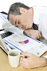 Image showing Businessman asleep at his desk on white background