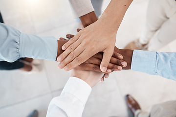 Image showing Hands, teamwork and motivation with business people standing in a huddle or circle together from above. Office, meeting and solidarity with a man and woman employee group joined in unity or trust