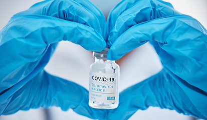 Image showing Covid, vaccine and heart with hands of doctor for medicine, and lab research with bottle. Medical, healthcare and drug with clinic worker holding treatment for pharmacy, innovation and science