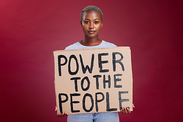 Image showing Poster, woman and studio banner power to the people sign by black woman vote, change and empowerment on red background. Portrait, girl and voter message with equality, transformation and human rights