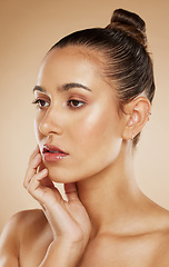 Image showing Beauty, natural and makeup girl thinking with healthy, radiant and cosmetic face touch. Attractive cosmetic model thoughtful feeling glowing skin with beige gradient studio background.