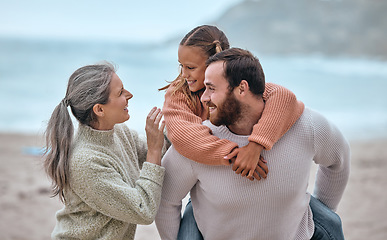 Image showing Family, love and piggy back at beach on holiday, vacation or trip. Support, care and grandma with father carrying girl outdoors, enjoying quality time together having fun or bonding by sandy seashore