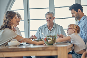 Image showing Big family, food and praying for gratitude and healthy lunch together while holding hands for love, religion and thanksgiving. Men, women and child together for healthy eating at home dining table