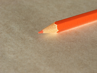 Image showing Orange pencil over paper