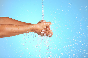 Image showing Hands, water and wash for clean hygiene, health or wellness against a blue studio background. Hand rinsing, washing or cleaning for fresh hygienic cleanse or hydration in care for skin on mockup