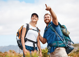 Image showing Hiking, happy and couple in nature, relax and smile, hand and pointing while talking and looking around. Friends, hikers and woman with man in forest, exercise, cardio and adventure outdoor together