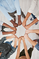 Image showing Team building, fist and hands in support of motivation circle by colleagues show community, trust and diversity above. Hand, people and collaboration with team in huddle for goal, mission and vision