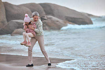 Image showing Grandmother, child and beach fun while on vacation for bonding, love and care while playing with water or waves. Senior woman and girl kid happy about travel, adventure and quality time at sea