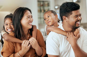 Image showing Happy, smile and children hugging their parents while sitting together in the living room at home. Happiness, love and girl kids embracing their mother and father while bonding and relaxing at house.