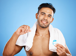 Image showing Dental care, floss and man cleaning teeth for oral hygiene routine, self care flossing or tooth healthcare. Mouth plaque treatment, aesthetic smile and beauty portrait of model with dental product