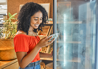 Image showing Supermarket, grocery store and customer black woman shopping for healthy food in fridge happy with price discount, sale or promotion. Groceries, small business store and vegan girl with green choice