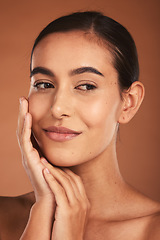 Image showing Skincare, beauty and face of Latina woman with smile, healthy and natural skin. Makeup, cosmetics and girl pose with hands for skincare products, spa and wellness isolated on brown background studio