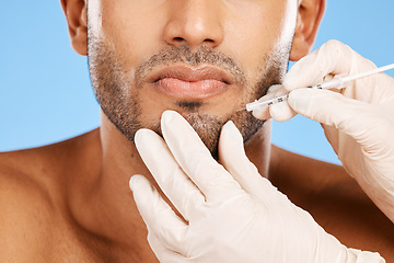 Image showing Beauty, skincare and face of man with botox injection on blue studio background. Healthcare, medical and male model with aesthetic plastic surgery treatment, dermatology or facial anti aging filler.