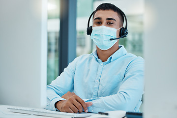 Image showing Call center, consultant and covid face mask at desk of telemarketing, CRM and customer support agent at office for help and advice. Male with headset for contact us service on website during covid 19