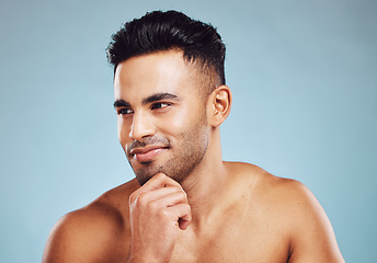 Image showing Male beauty, skincare and health of India model thinking about dermatology, health and wellness on blue studio background. Face of man with smile for healthy skin after facial detox and self care