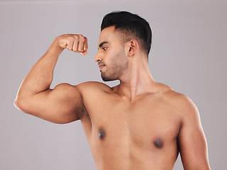Image showing Muscle, arm and man strong from training for health, goal and body against a grey mockup studio background. Power, pride and athlete with bicep to show progress with workout, exercise and fitness