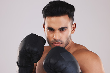 Image showing Sports, boxing and portrait of man with boxing gloves isolated on white background studio. Fitness, exercise and Indian man training with determination, focus and motivation for winning match or game