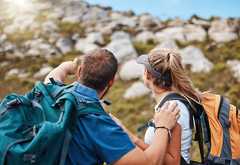 Image showing Hiking, couple and mountain in nature with rock, climbing and challenge for fitness, exercise and performance. Hand, man and woman looking up hill, hikers, morning and cardio workout adventure