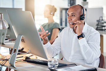 Image showing Helpdesk, customer service and male call center agent giving advice to client online using computer. Crm, customer service and consultant or telemarketing agent offering support on pc in agency