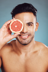 Image showing Happy studio portrait, grapefruit man for skincare wellness beauty and face smile health against wall. Young cosmetics model, fruit happiness for healthy facial skin or vitamin c with blue background