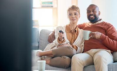 Image showing Couple, bonding or television control on sofa for home movie, house show or living room multimedia streaming remote. Happy smile, black woman or mature man watching on tv subscription, coffee or tea