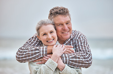 Image showing Beach, hug and portrait of senior couple relaxing in Australia with smile, love and happiness on pension. Elderly, marriage and happy retirement people enjoy ocean walk break together.