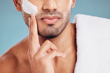 Image showing Skincare, facial cream and hands of man using lotion, face cream and skincare product for shaving. Beauty, healthy skin and male apply moisturizer, foam and product to shave on blue background studio