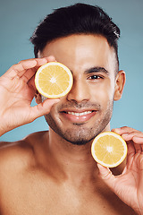 Image showing Lemon, vitamin c and natural beauty skincare cosmetics for facial, body care and man happy with results on studio background. Smile model portrait, organic fruit dermatology, healthy and clean face