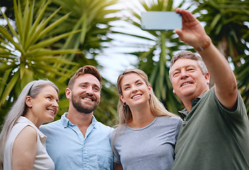 Image showing Phone, family and selfie with a man, woman and inlaws posing for a picture together in a garden or yard outdoor. Mobile, happy and smile with a senior father, mother and relatives taking a photograph